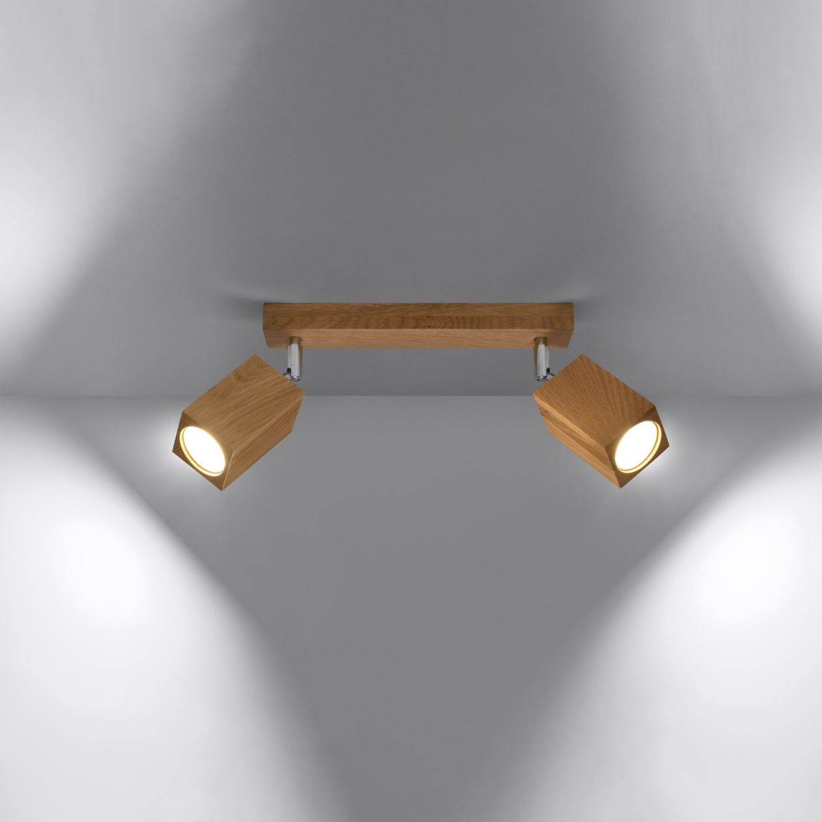 Plafonnier allumé diffusant deux faisceaux lumineux orientables dans la pièce