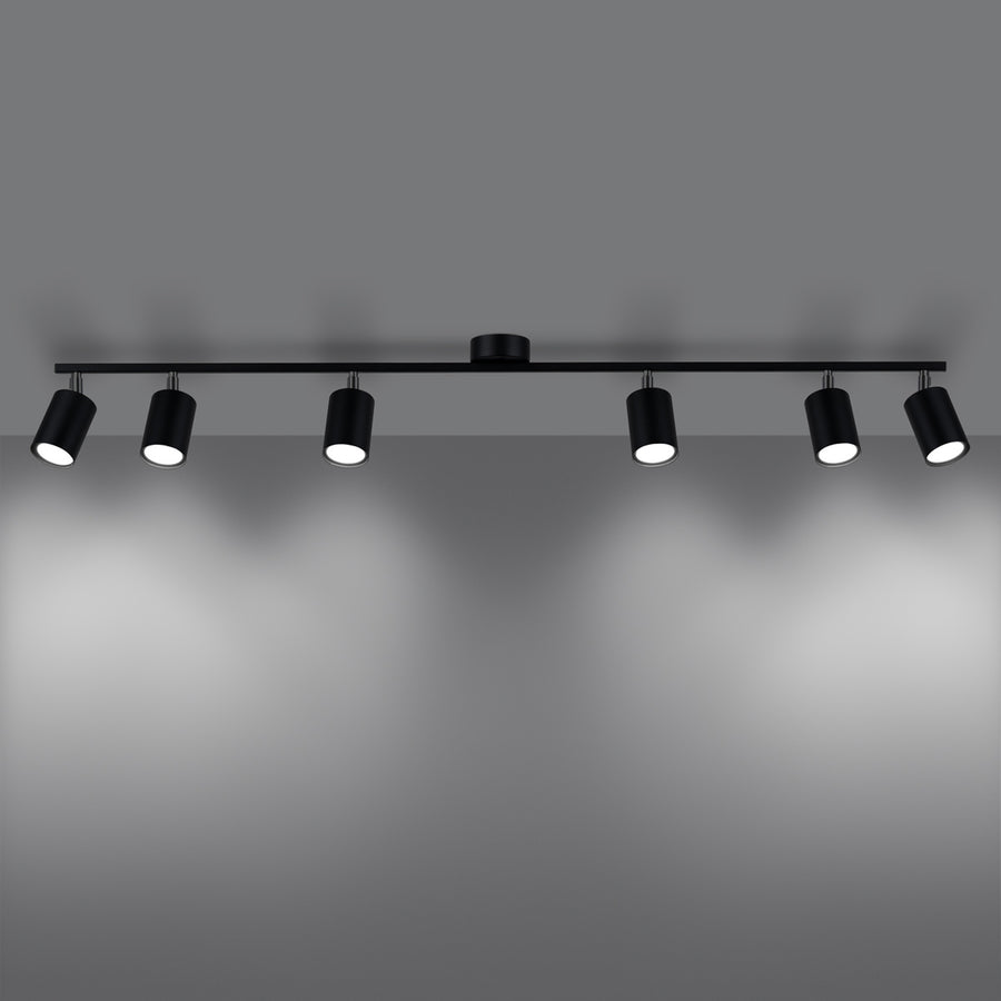 Rendu allumé du plafonnier, six faisceaux lumineux projetés sur un mur gris
