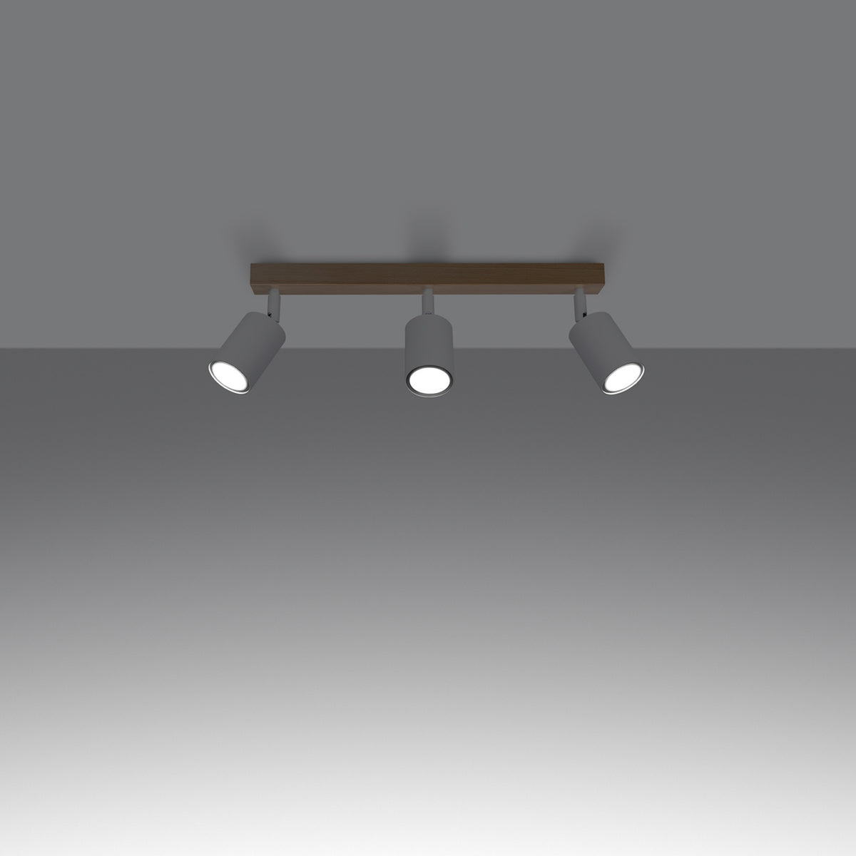 Mise en ambiance sur plafond gris, trois projecteurs allumés éclairent vers le bas.
