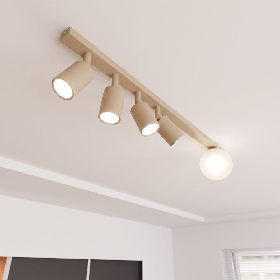 Gros plan du plafonnier au plafond, spots cylindriques orientables et sphère allumés