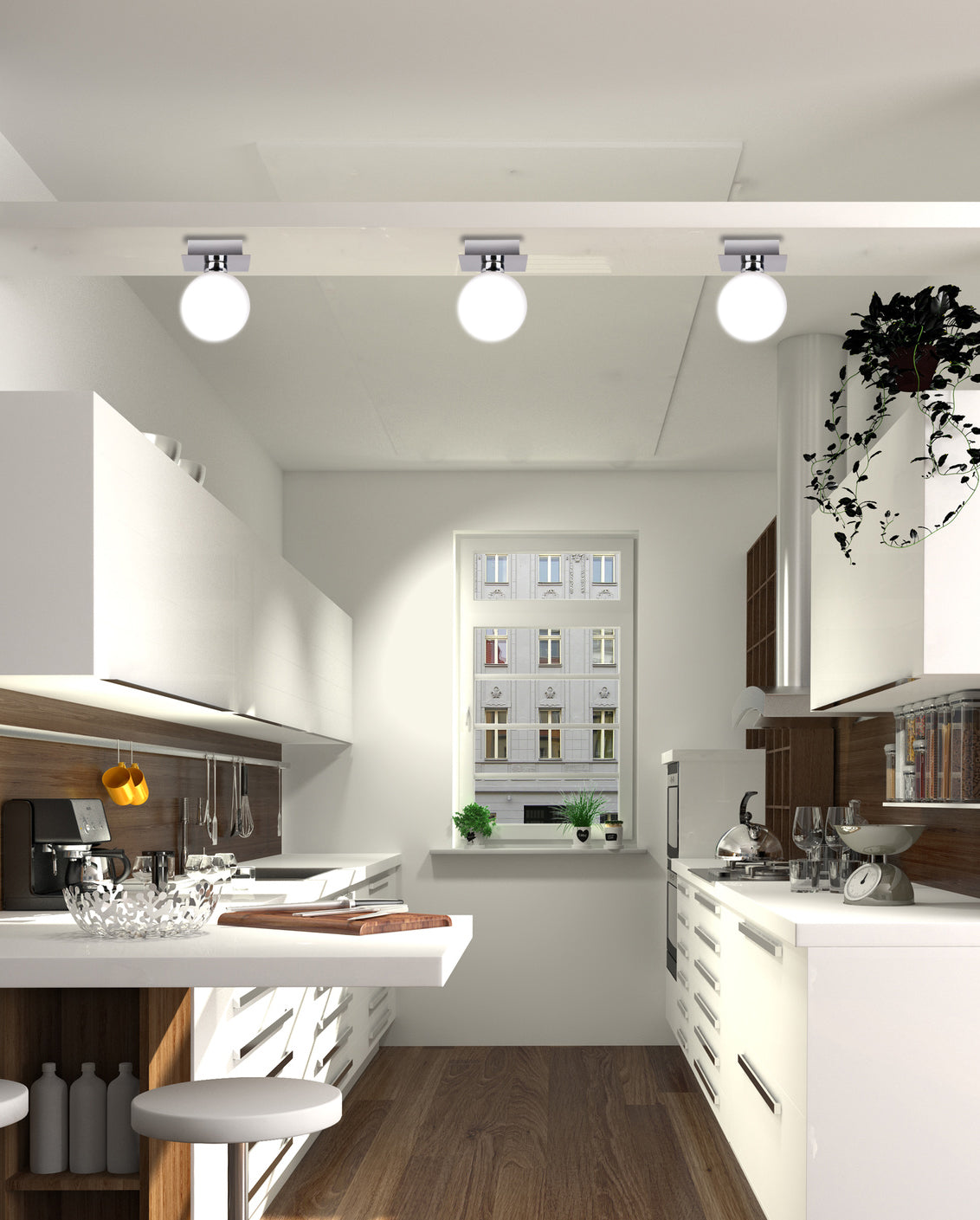 Vue en enfilade d'une cuisine blanche éclairée par trois globes fixés