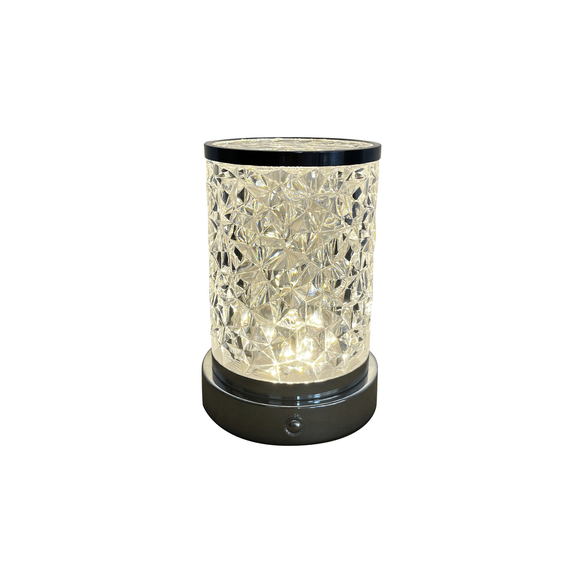 Lampe à poser transparente cylindrique, motif cristal, base noire, sur fond blanc.