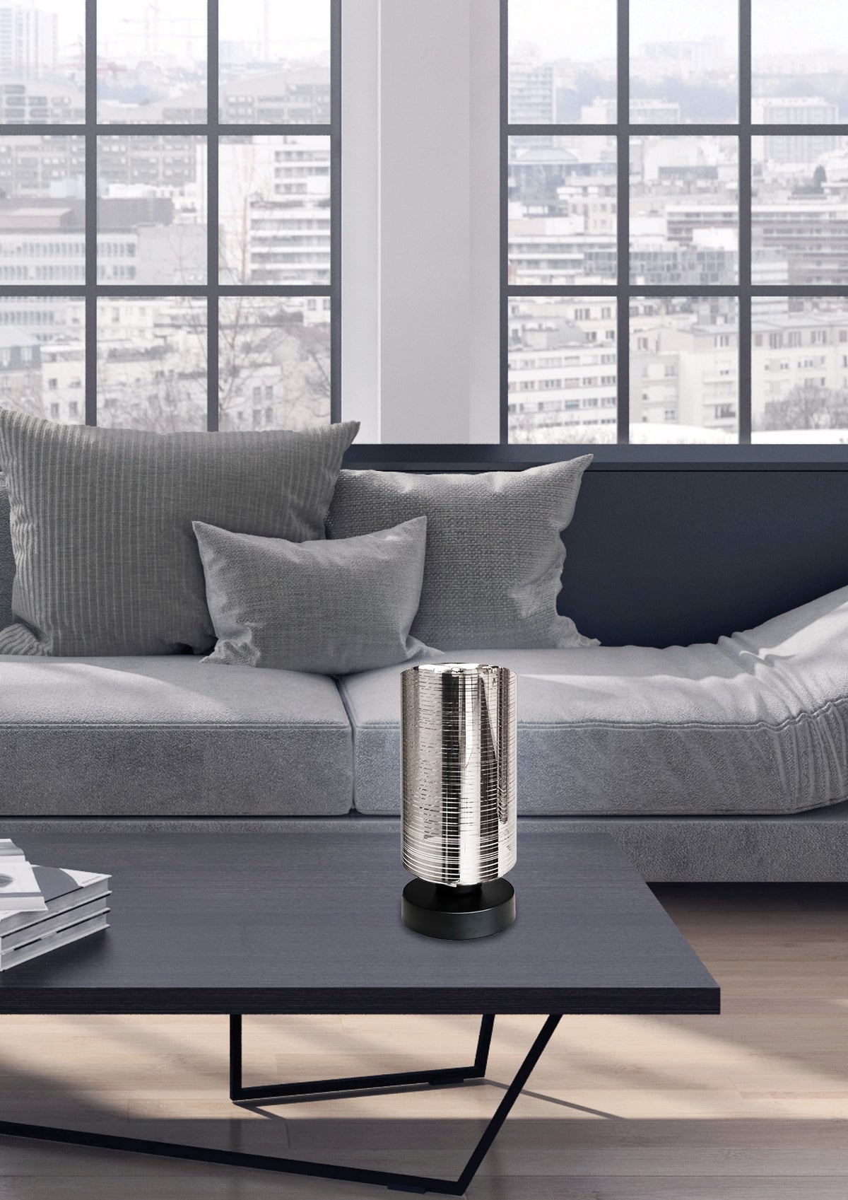 Mise en ambiance sur table basse noire devant canapé gris et baie vitrée