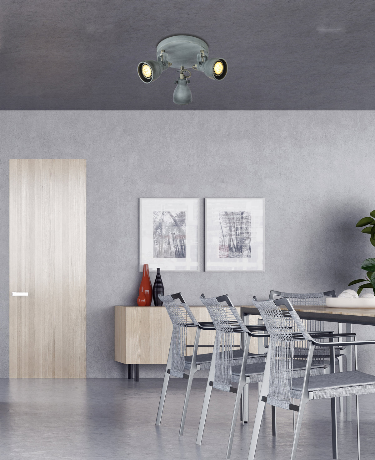 Vue large d'une pièce grise équipée du plafonnier orientable, éclairant une table à manger.