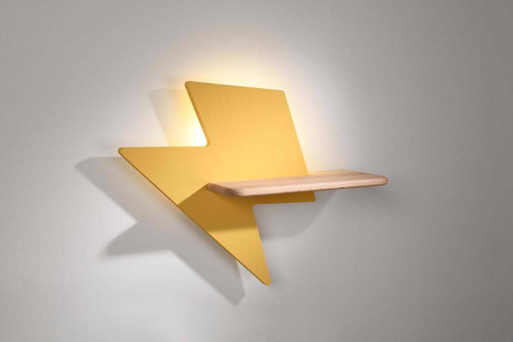 Luminaire mural éclair jaune sur mur beige, étagère bois et éclairage indirect