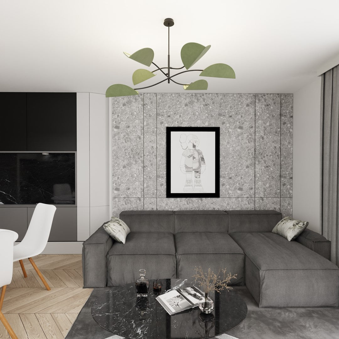 Plafonnier suspendu dans un salon gris avec canapé d'angle, mur effet béton et tableau.