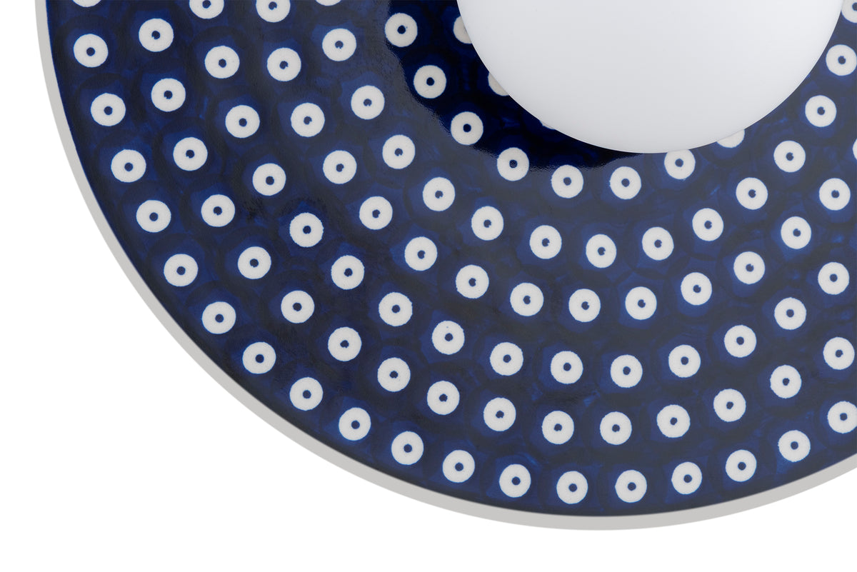 Détail de la finition : motif régulier de pois blancs sur céramique bleu brillant