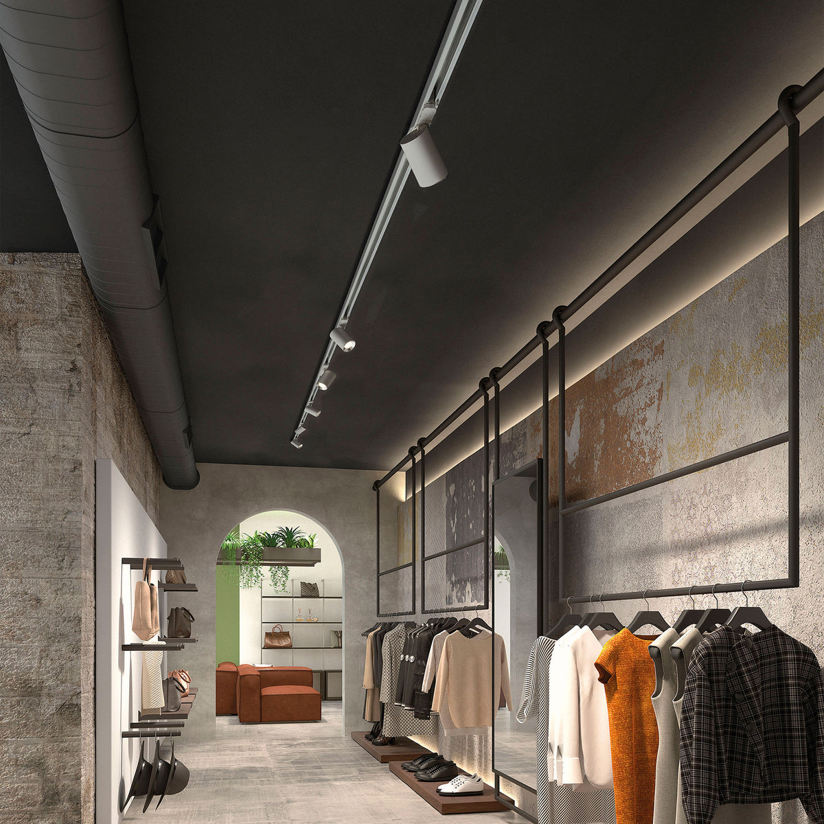 Mise en ambiance dans une boutique de vêtements avec rail de spots au plafond.
