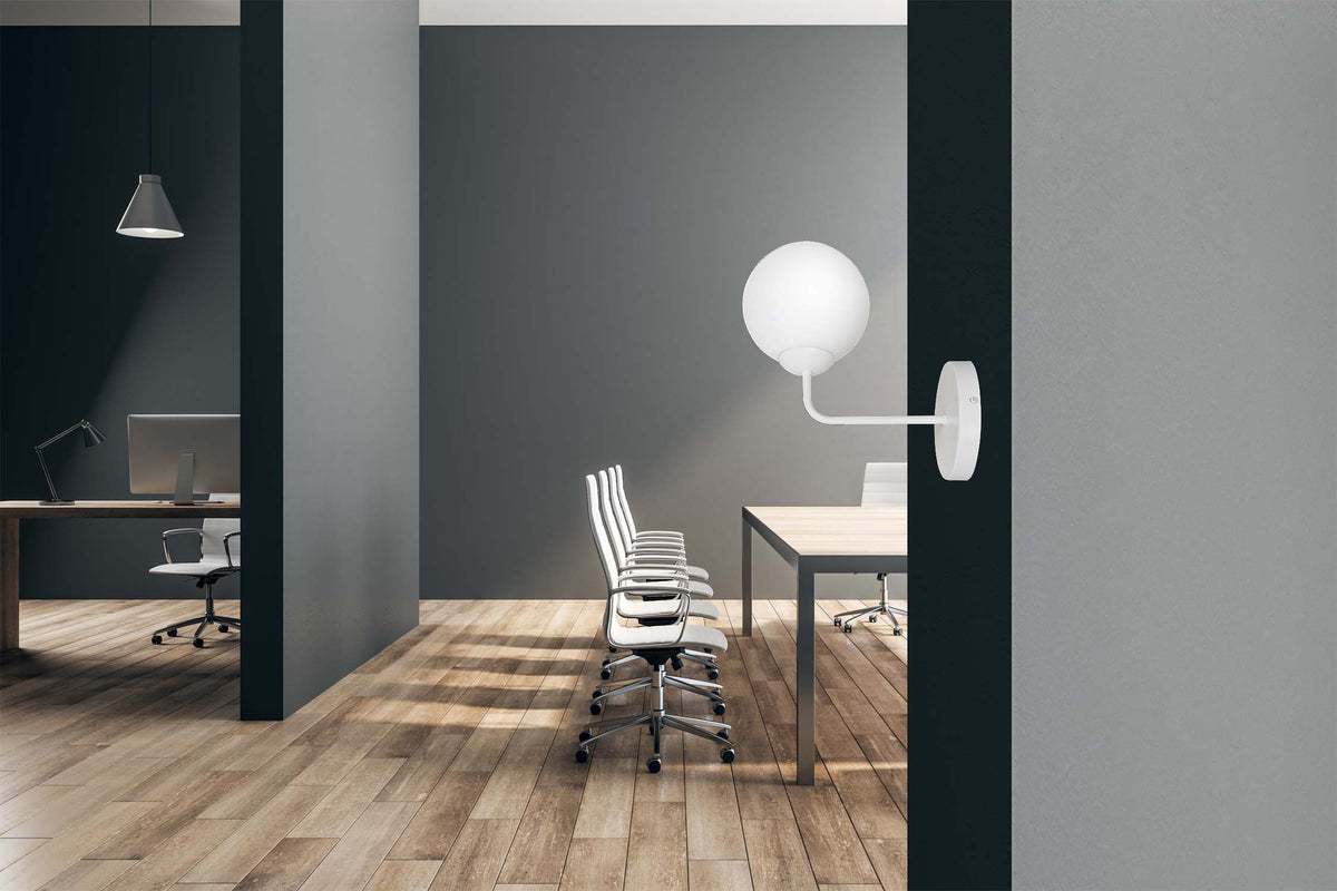 Vue en situation dans un bureau, applique blanche allumée au-dessus d'une table