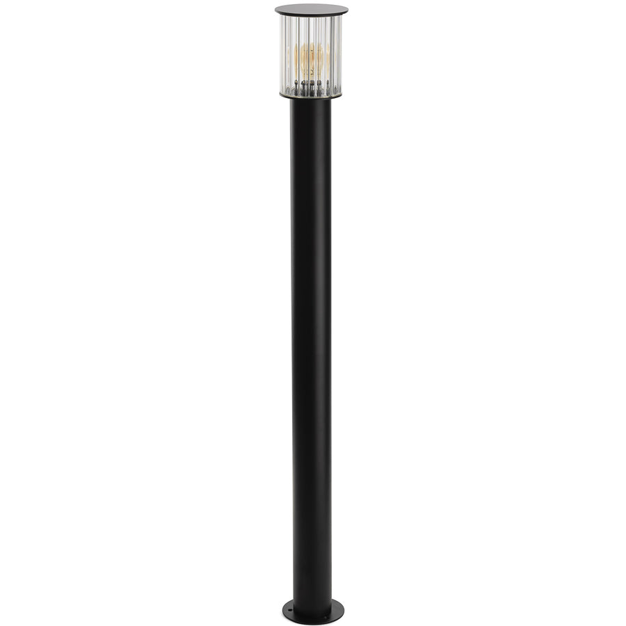Vue de face du lampadaire noir éteint, détaillant le long fût et la base circulaire.