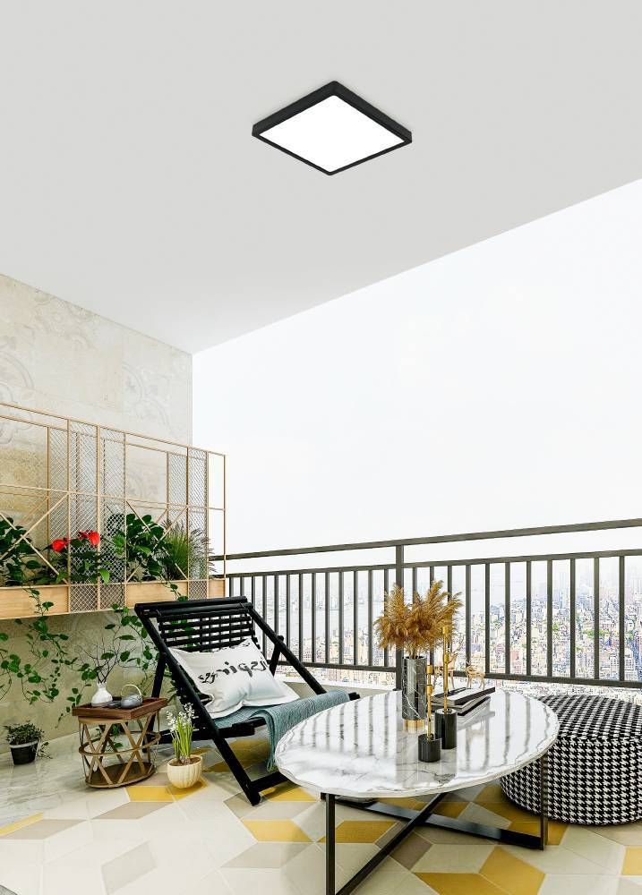 Plafonnier noir installé au plafond d'un balcon urbain avec mobilier et plantes.