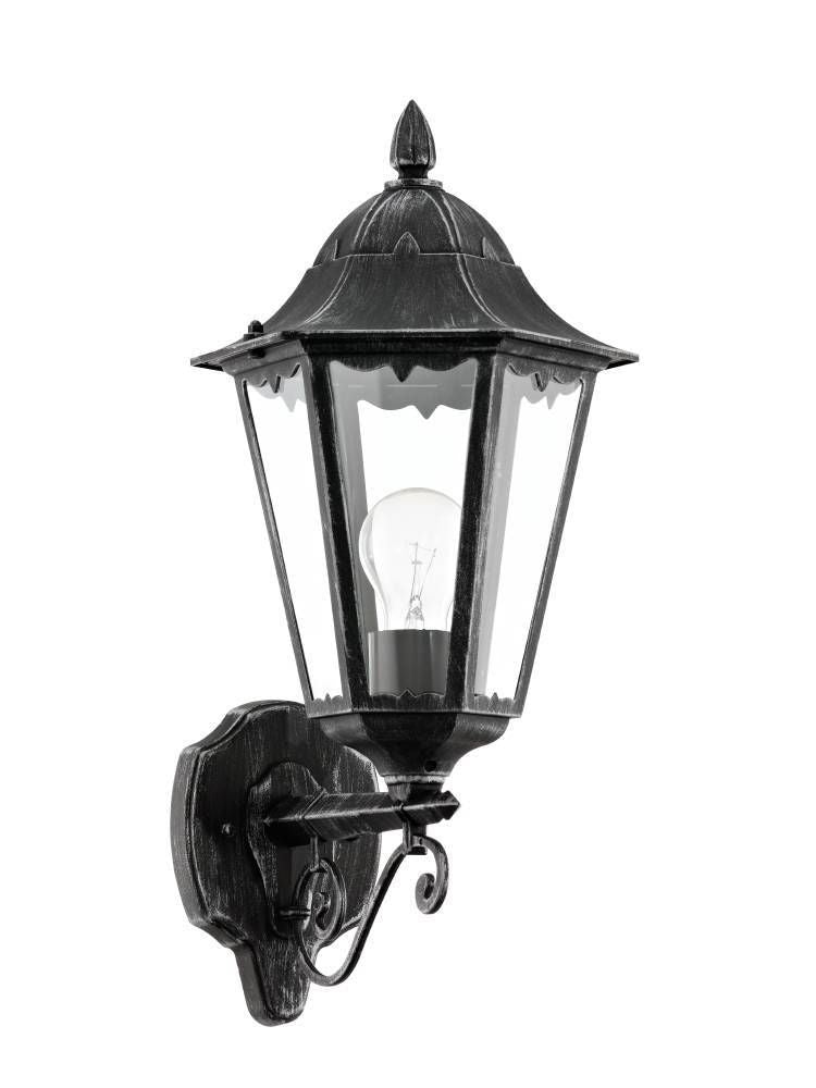 Applique murale noire style lanterne avec verre transparent et ampoule visible.