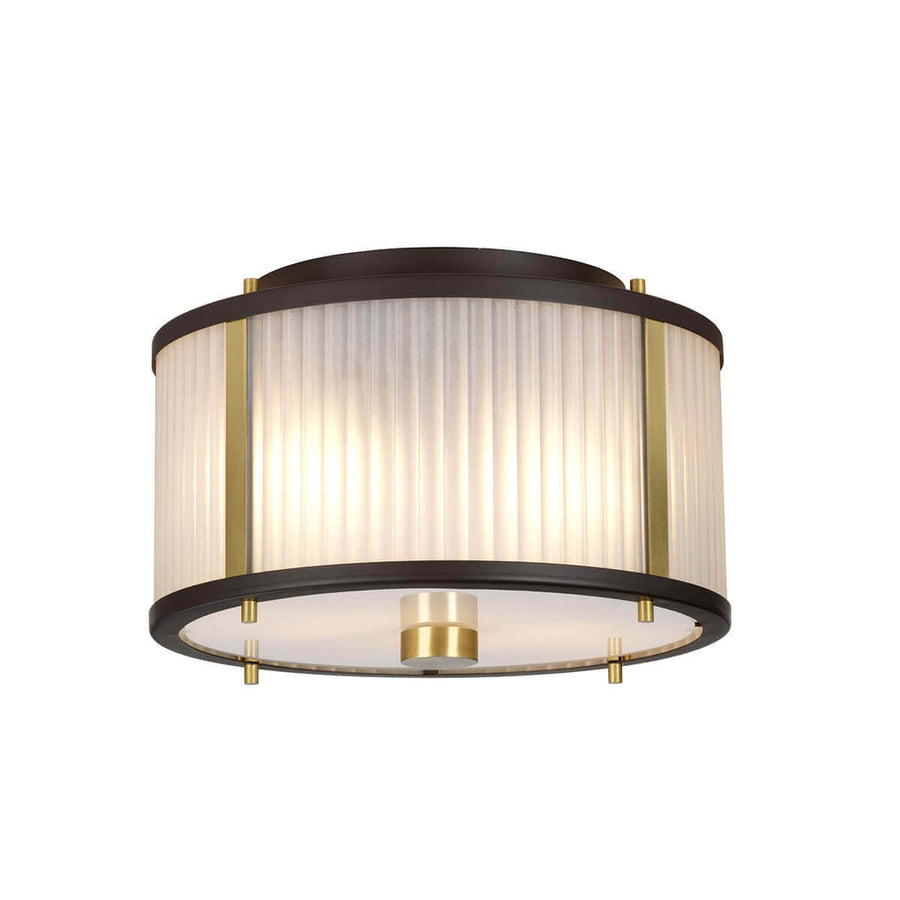 Vue rapprochée du bas du luminaire montrant l'abat-jour cylindrique en verre strié et les détails dorés