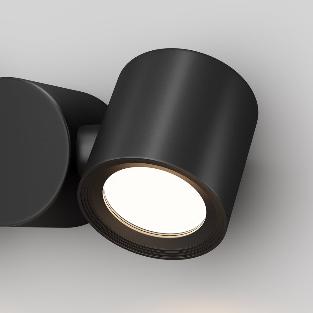 Gros plan sur un spot cylindrique noir et sa lentille lumineuse