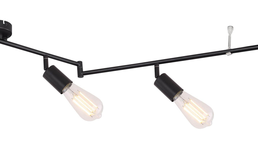 Détail rapproché des douilles noires et ampoules Edison transparentes allumées