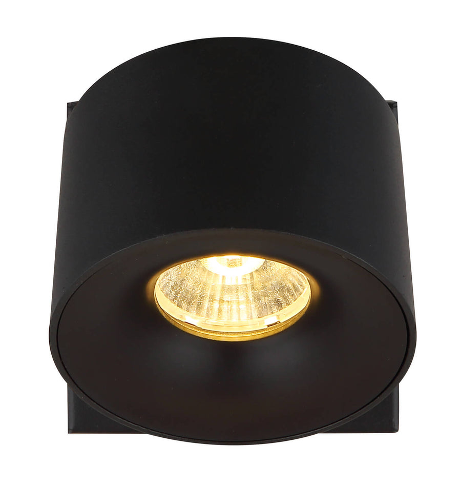 Vue de face de la tête ronde, LED dorée allumée sous lentille transparente.