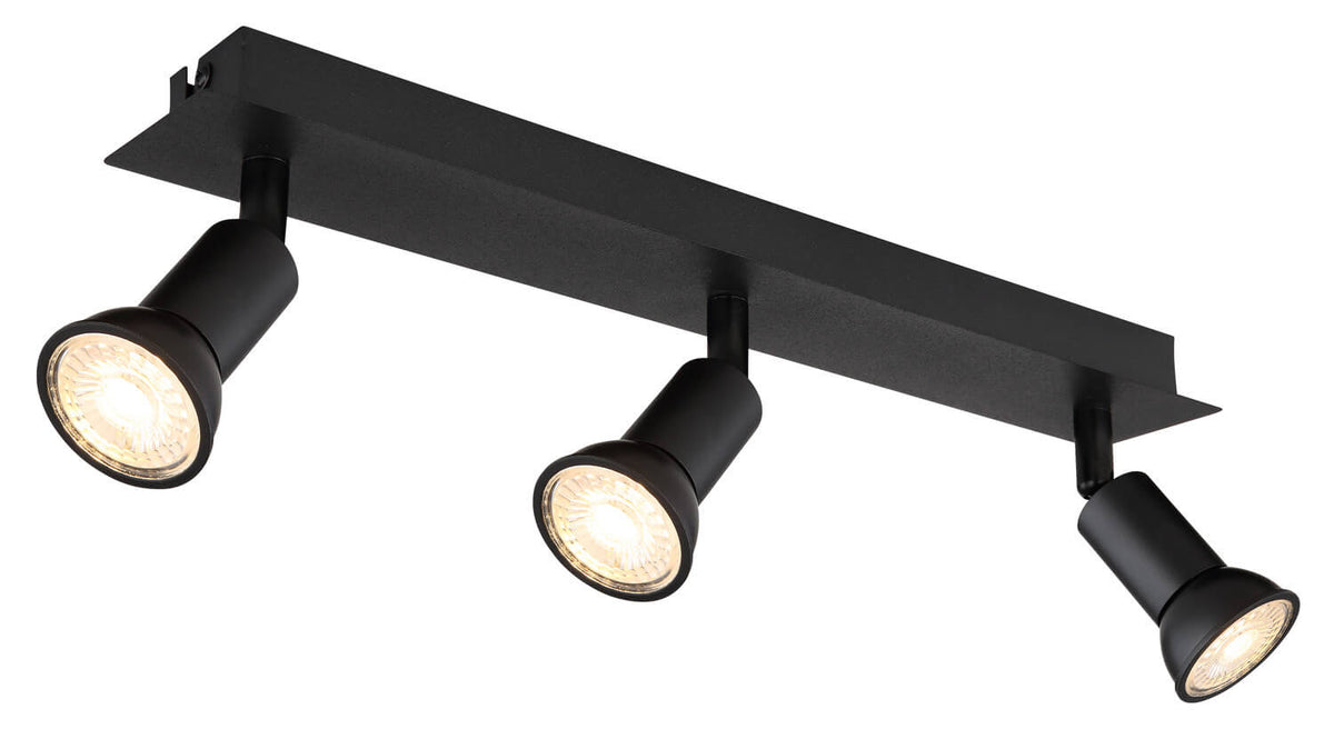 Vue inclinée du luminaire montrant les trois têtes cylindriques et leur support allongé.