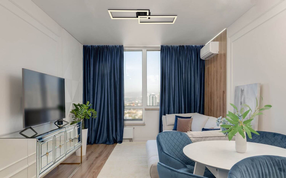 Mise en ambiance dans un salon moderne, plafonnier noir fixé au plafond blanc.