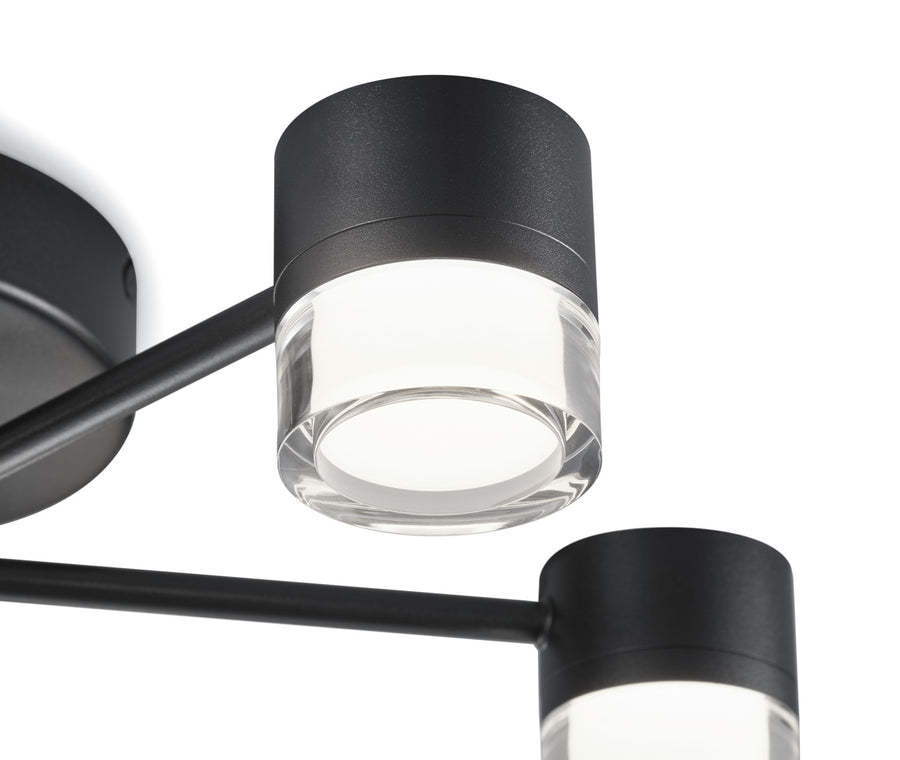 Gros plan sur un diffuseur en verre et la finition noire mate du bras
