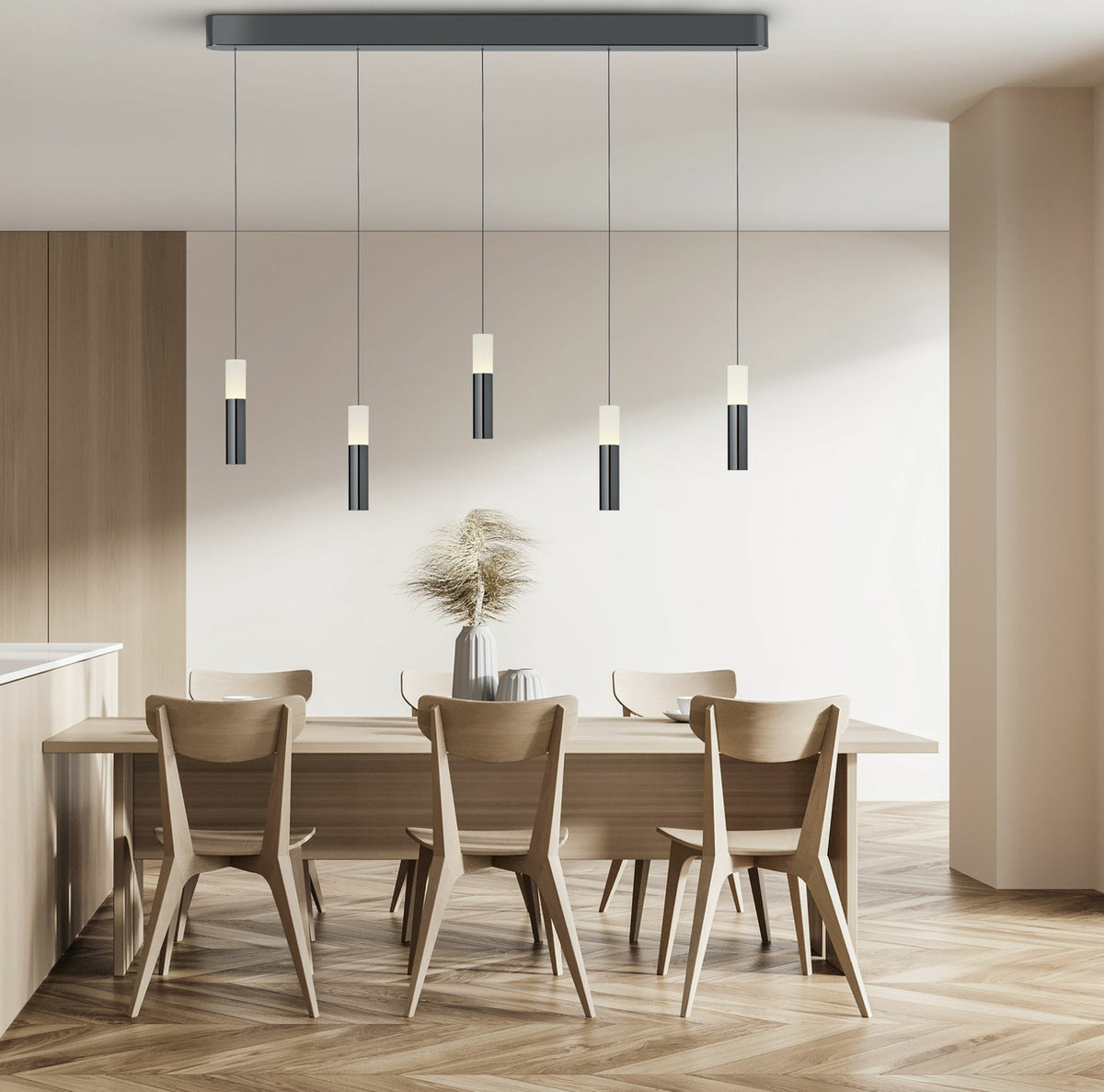 Suspension à cinq cylindres noirs et blancs au-dessus d'une table en bois clair