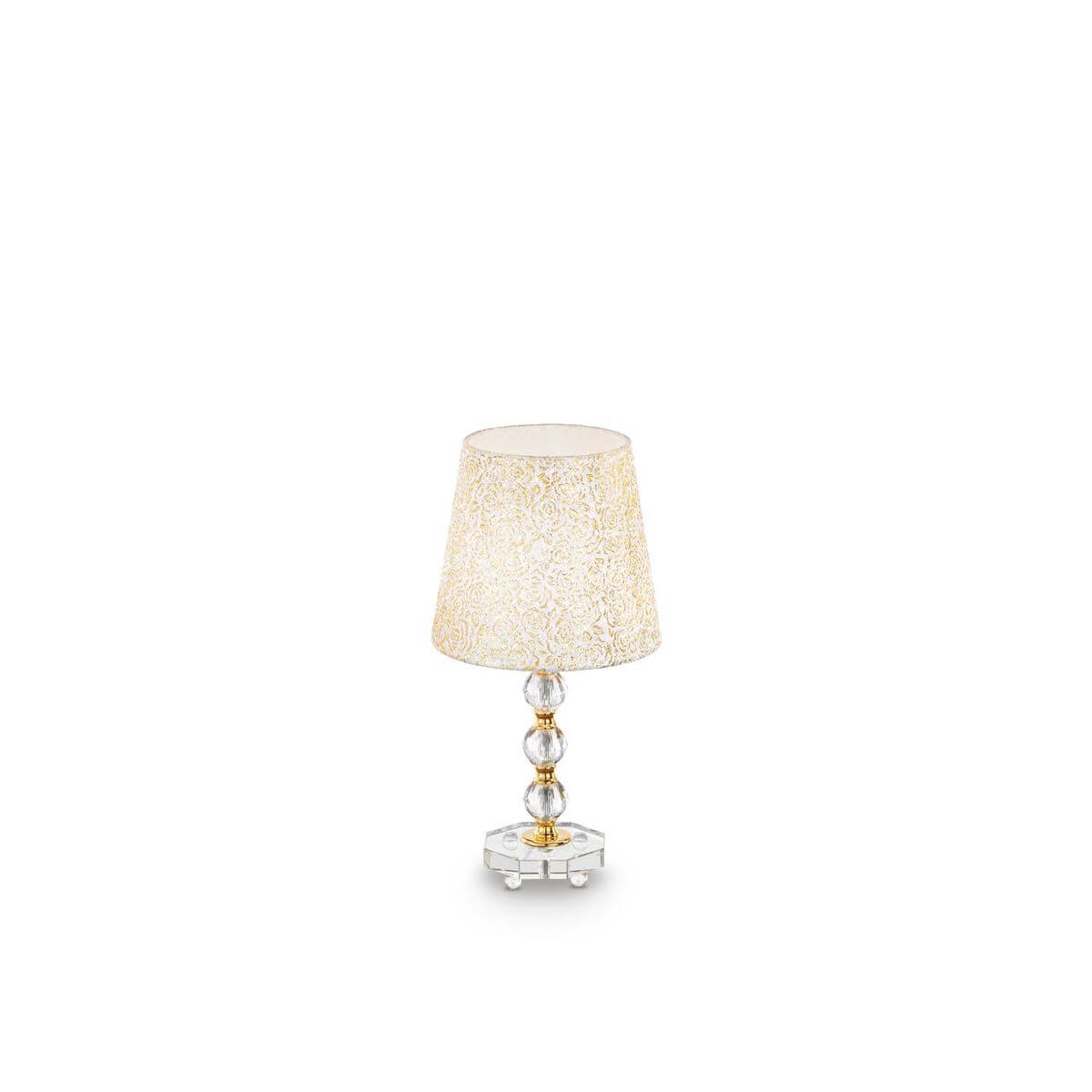 Lampe à poser dorée de face, abat-jour conique à motif floral, socle en verre facetté