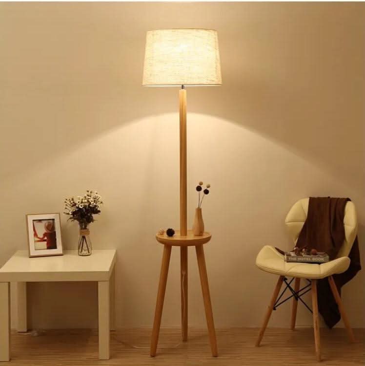 Lampadaire allumé en ambiance salon, table d'appoint et fauteuil, lumière chaude