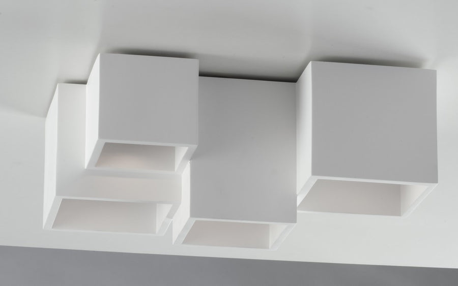 Perspective latérale du plafonnier illustrant l'assemblage des blocs cubiques blancs