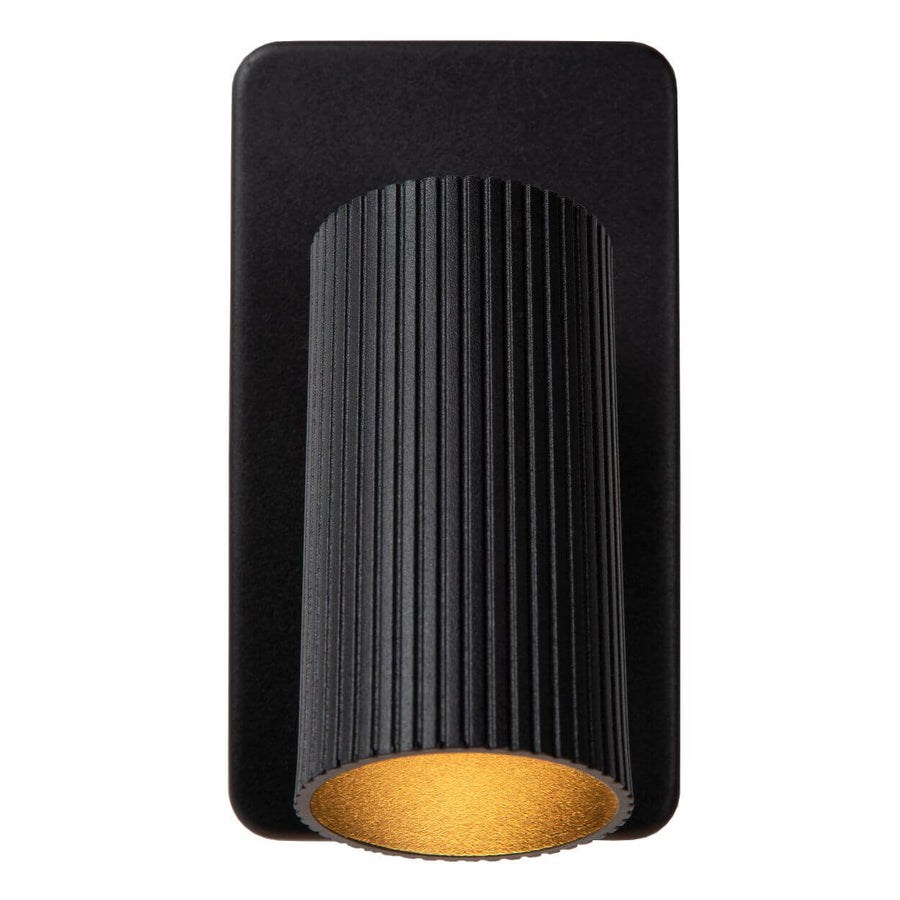 Vue de face du luminaire plaqué, cylindre strié et disque doré visible