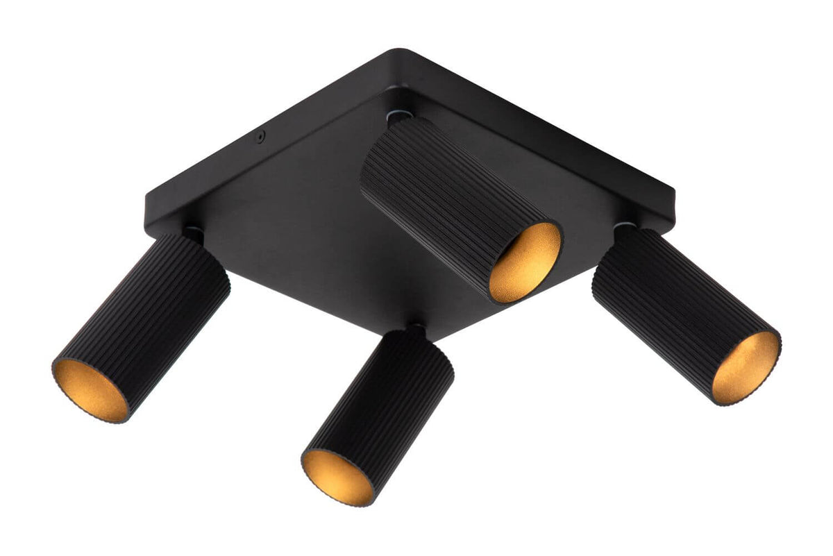Autre angle du luminaire, montrant les quatre cylindres noirs striés fixés sur base carrée.