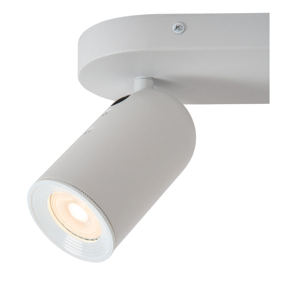 Détail rapproché d'un projecteur cylindrique blanc allumé sous tous les angles