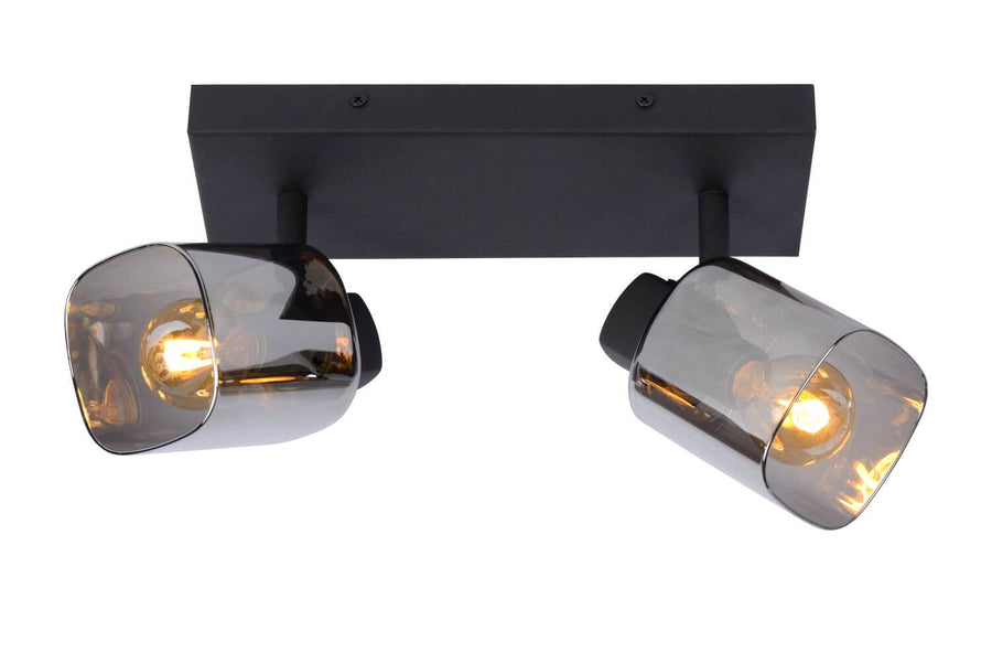 Vue rapprochée des deux spots noirs orientables et de leurs diffuseurs cylindriques en verre fumé.