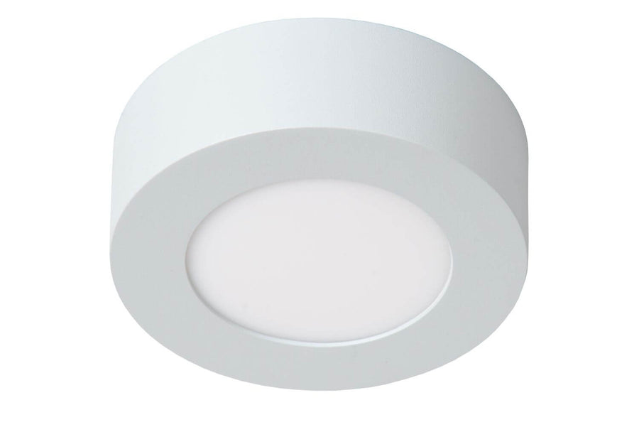 Luminaire vu de biais, couronne blanche et verre opalin éteint au centre