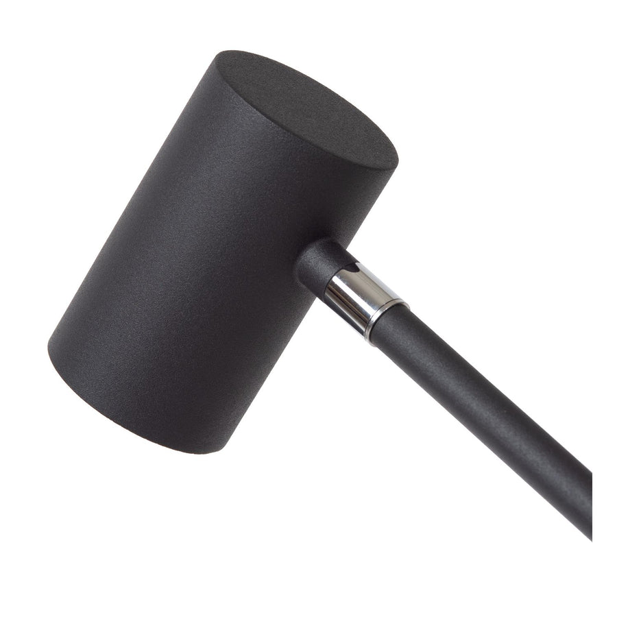 Détail de la tête cylindrique noire et de son raccord chromé sur la tige.