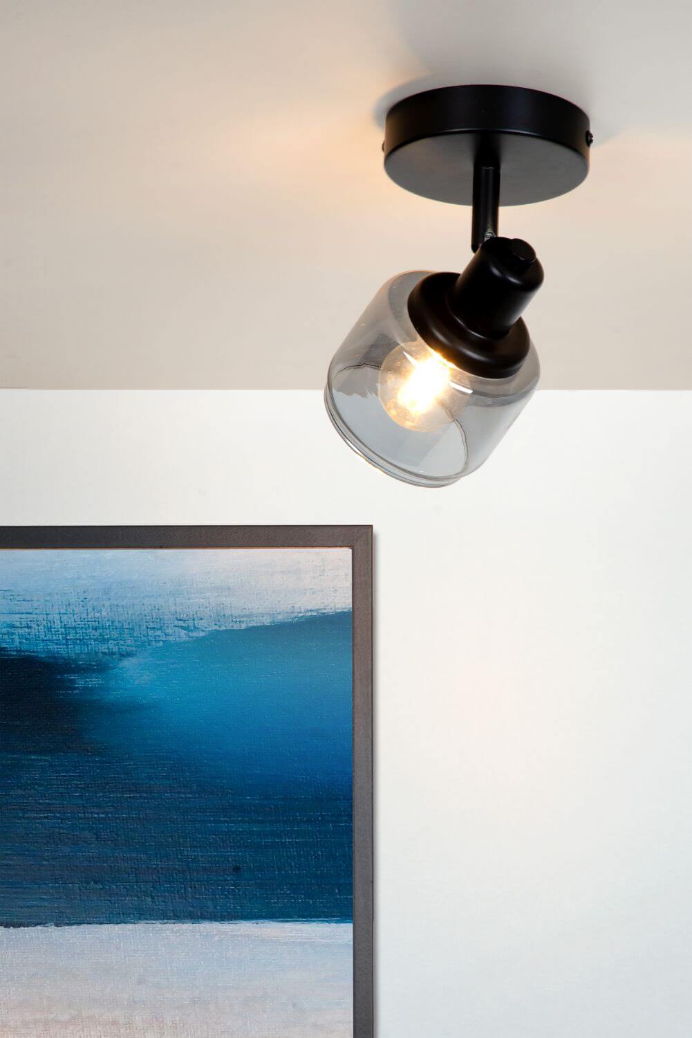 Mise en ambiance du luminaire fixé au plafond devant une peinture bleue