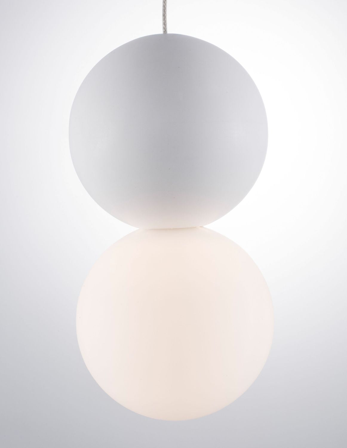 Gros plan sur les deux globes superposés, la partie basse diffuse une lumière chaude.