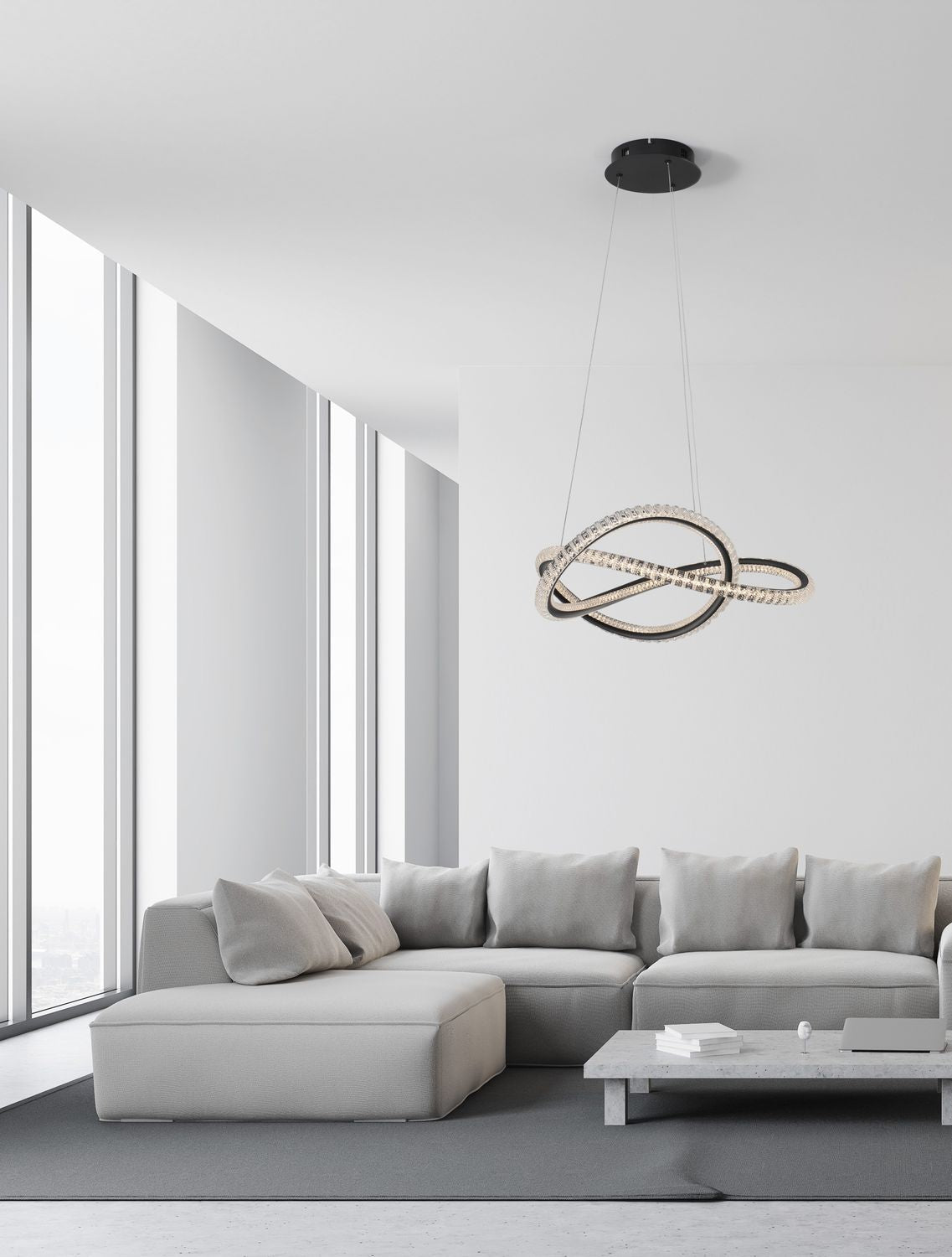 Suspension noire allumée au-dessus d'un canapé gris dans un salon lumineux