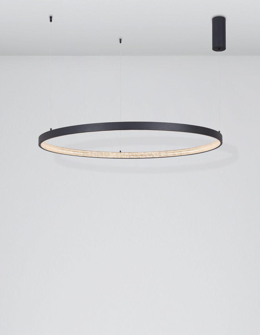 Vue plongeante du luminaire allumé, anneau circulaire éclairé dans une pièce claire.