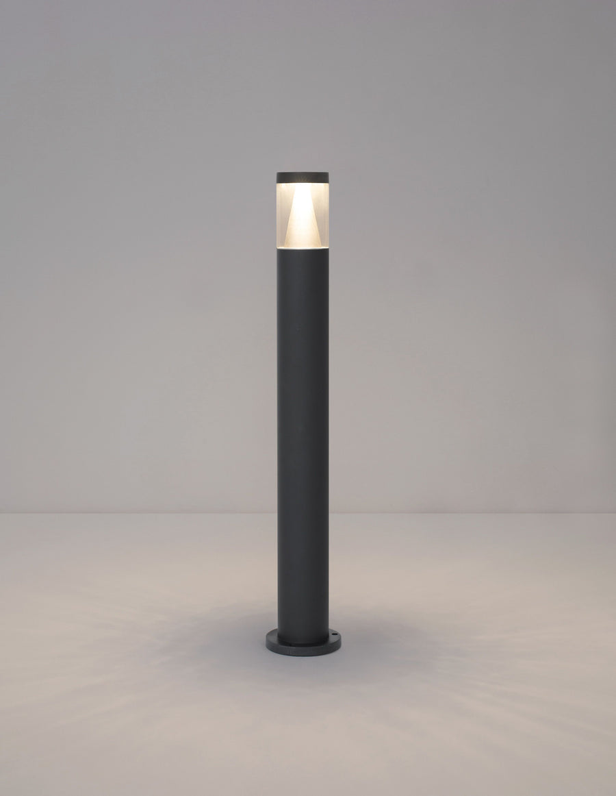 Borne allumée diffusant une lumière chaude en partie haute sur fond neutre.