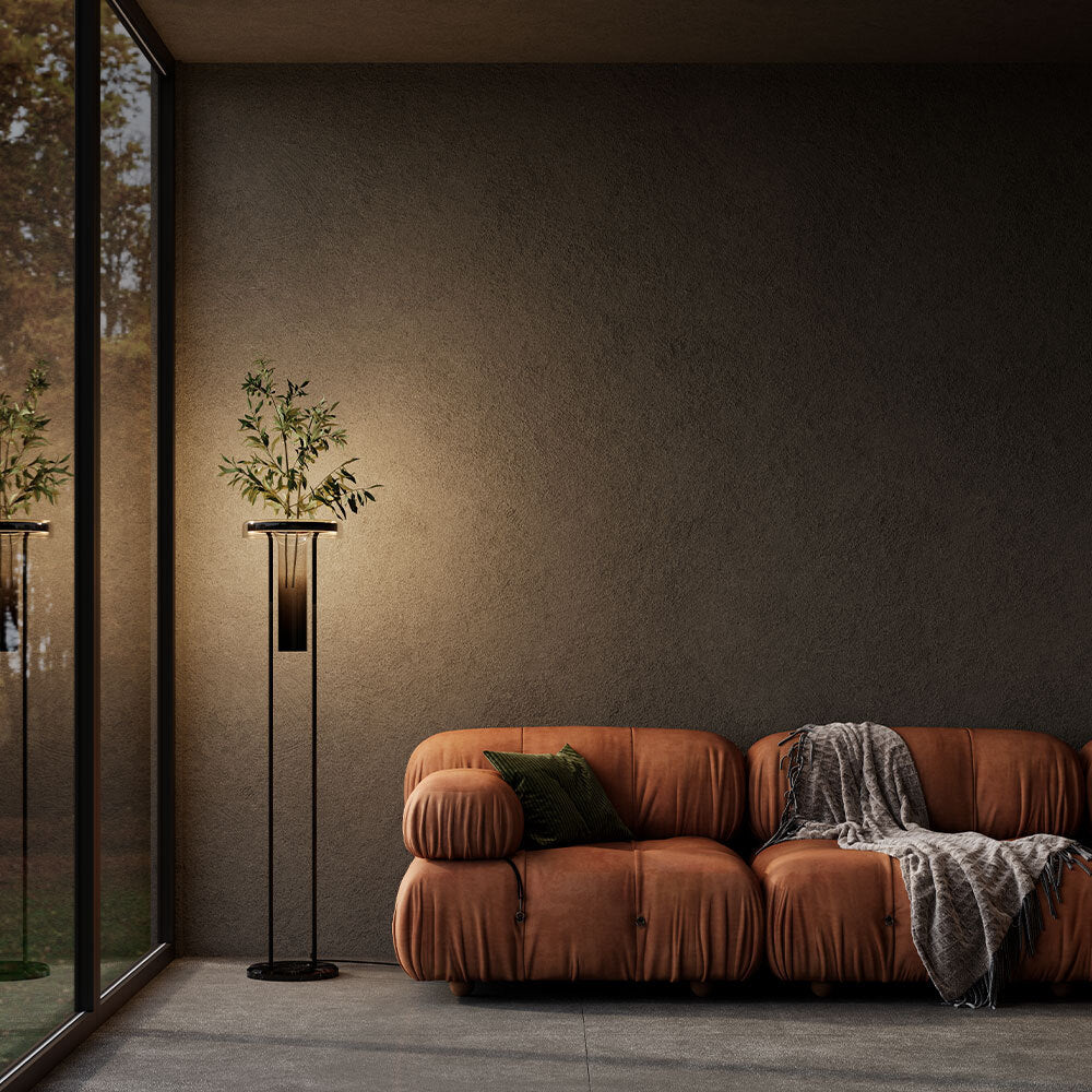 Mise en ambiance sombre, lampadaire allumé près d'un canapé en cuir