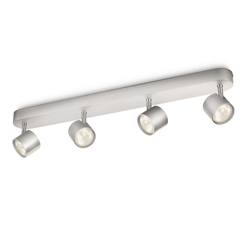 Plafonnier gris à quatre spots cylindriques orientables fixés sur une barre rectangulaire.