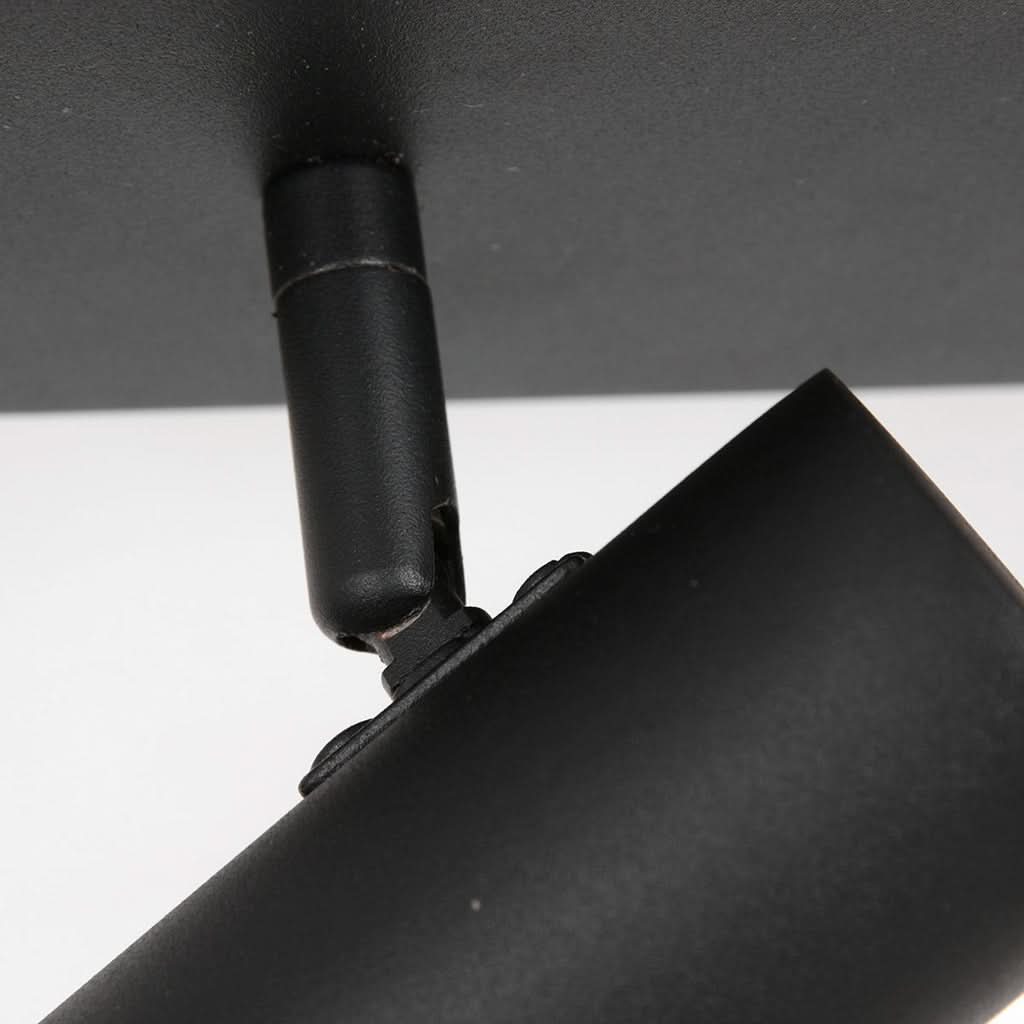 Détail du bras articulé noir et de la rotule reliant le socle au projecteur