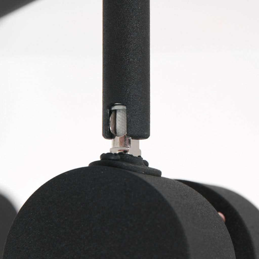 Zoom sur l'articulation chromée reliant la tige au projecteur cylindrique