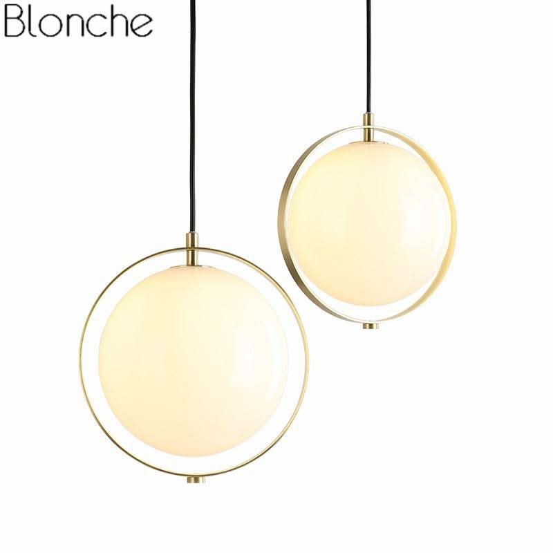 Gros plan sur deux globes de verre suspendus avec leur anneau métallique doré