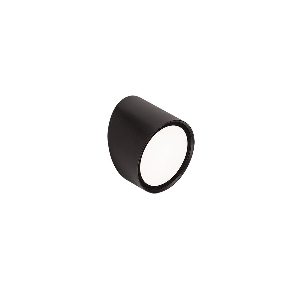 Vue de trois quarts du luminaire cylindrique noir avec diffuseur blanc