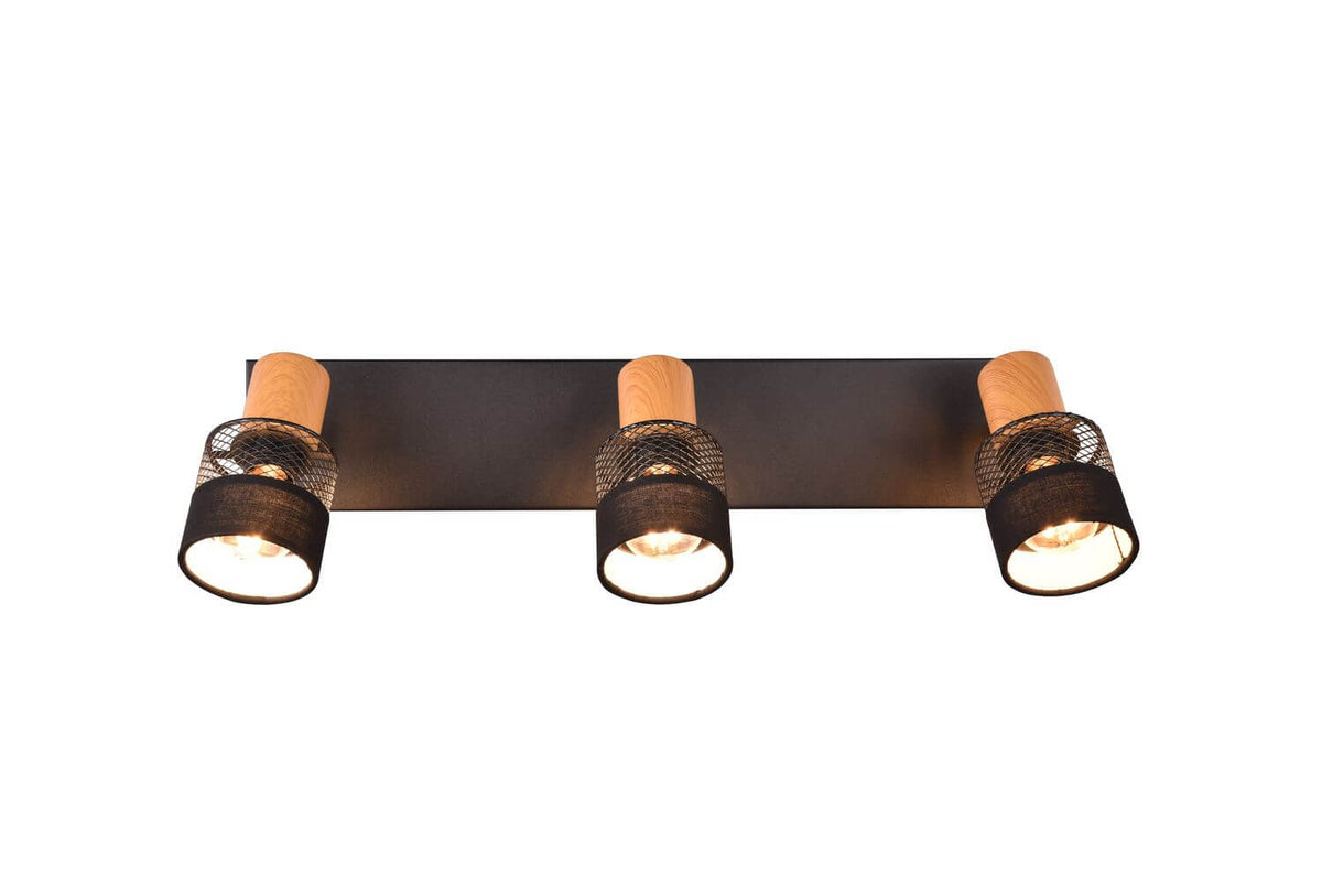 Vue frontale du plafonnier trois lumières, barre rectangulaire noire et diffuseurs cylindriques.