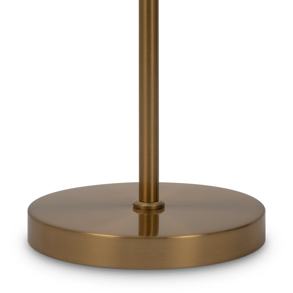 Détail du socle rond en métal doré brossé et de la tige