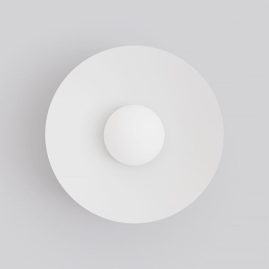 Vue de face montrant le disque rond blanc et la sphère en verre opalin