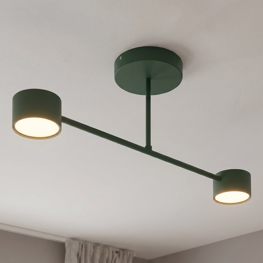 Détail rapproché des deux têtes cylindriques allumées sous un plafond blanc.