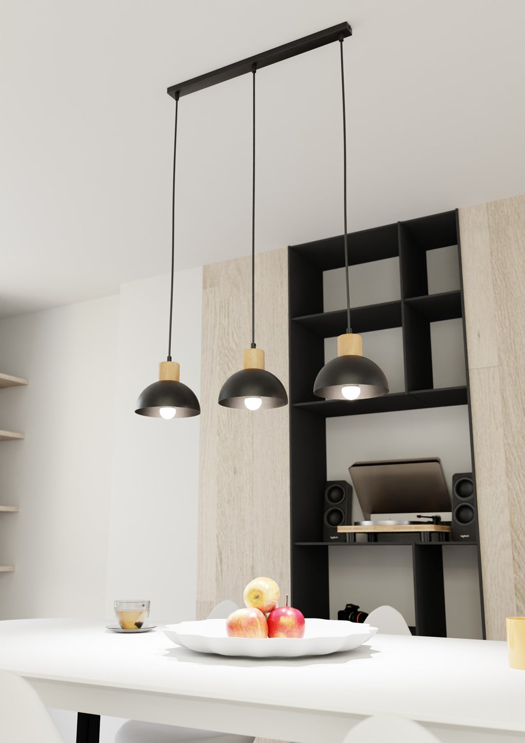 Mise en ambiance au-dessus d'une table blanche, avec bibliothèque noire et pommes.