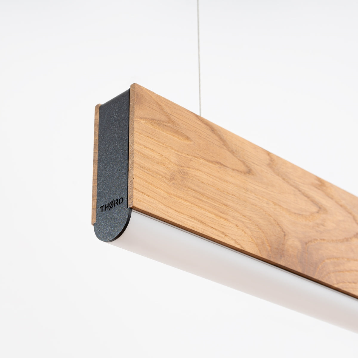 Détail de l'embout métallique noir et du profil en bois, finition soignée.